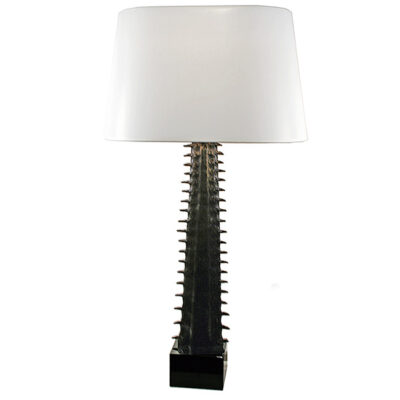 A black lamp with white shade on top of it.