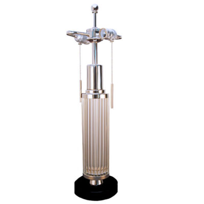 A tall glass lamp with metal base and top.