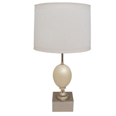 A white lamp with a silver base and shade.
