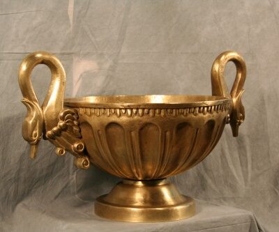A Solid Brass Double Headed Swan Centerpiece with two swans on it.