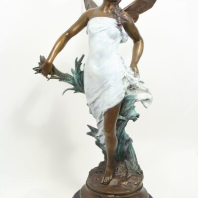 A Art Nouveau Bronze Sculpture of Winged Maiden by Adrien Guadez holding a flower.