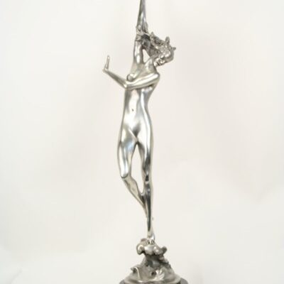 A Harriet Frishmuth Crest of the Wave Bronze Figurine of a woman on a stand.