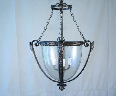A French Empire Style Cast Bronze Lantern hanging light fixture with a glass shade.