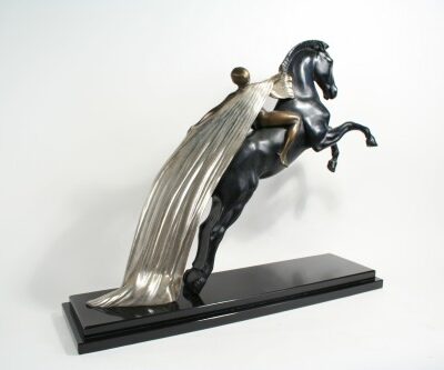 A Art Deco Bronze Statue Nude on Horseback by Charles of a man riding a horse.