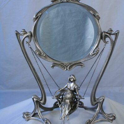 An Art Nouveau Boudoir Mirror with Silver Swinging Girl Figurine.