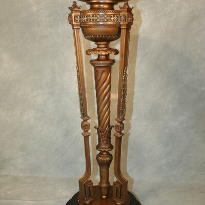 An Neoclassical Cast Bronze Greek Key Pedestal table with a black base.