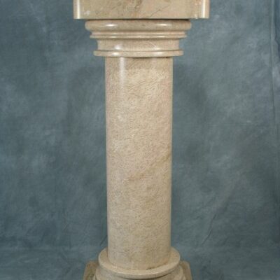 A Large Doric Natural Marble Stone Pedestal on a blue background.