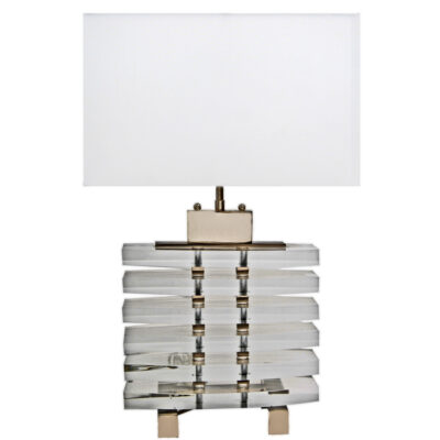 A lamp is made of clear acrylic and has a white shade.