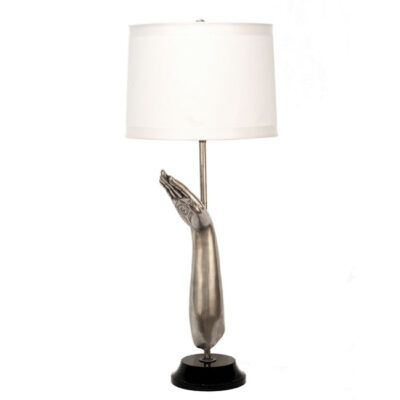 A silver lamp with a white shade on top of it.
