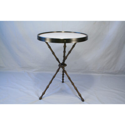 A table with a glass top and metal legs.