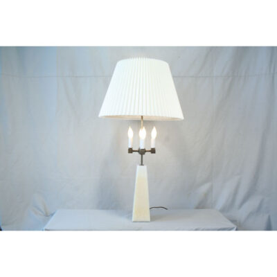 A white lamp sitting on top of a table.