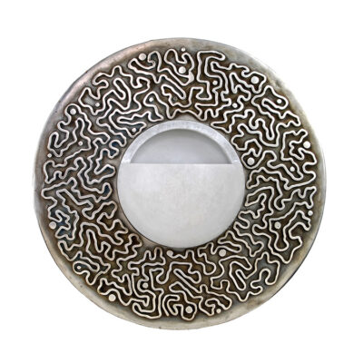 A round metal object with a white background.