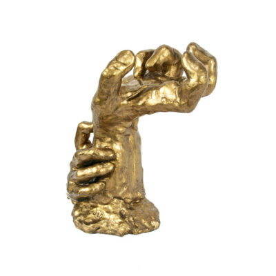 A gold statue of a hand with one arm raised.