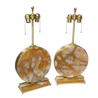 A pair of marble lamps with brass bases